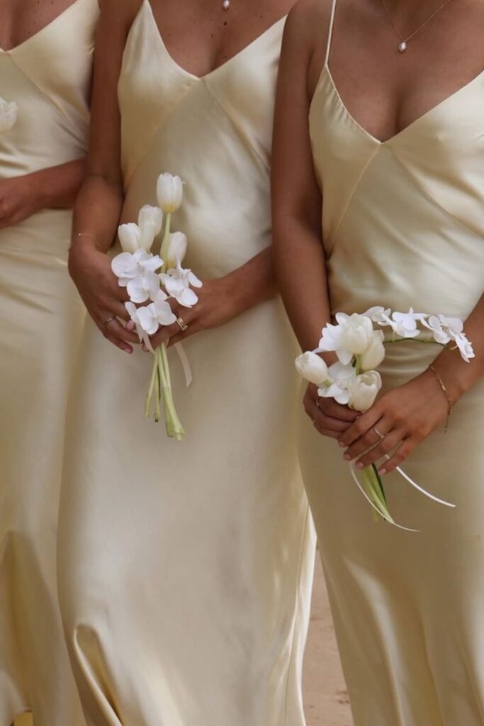 bridesmaids at a wedding with a 2027 floral trend of small bouquets