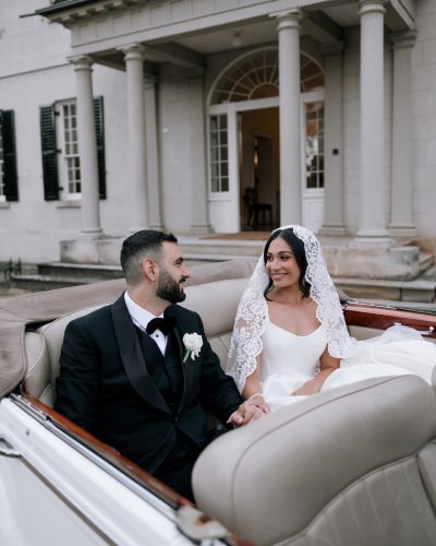 A bride and a groom in a car.