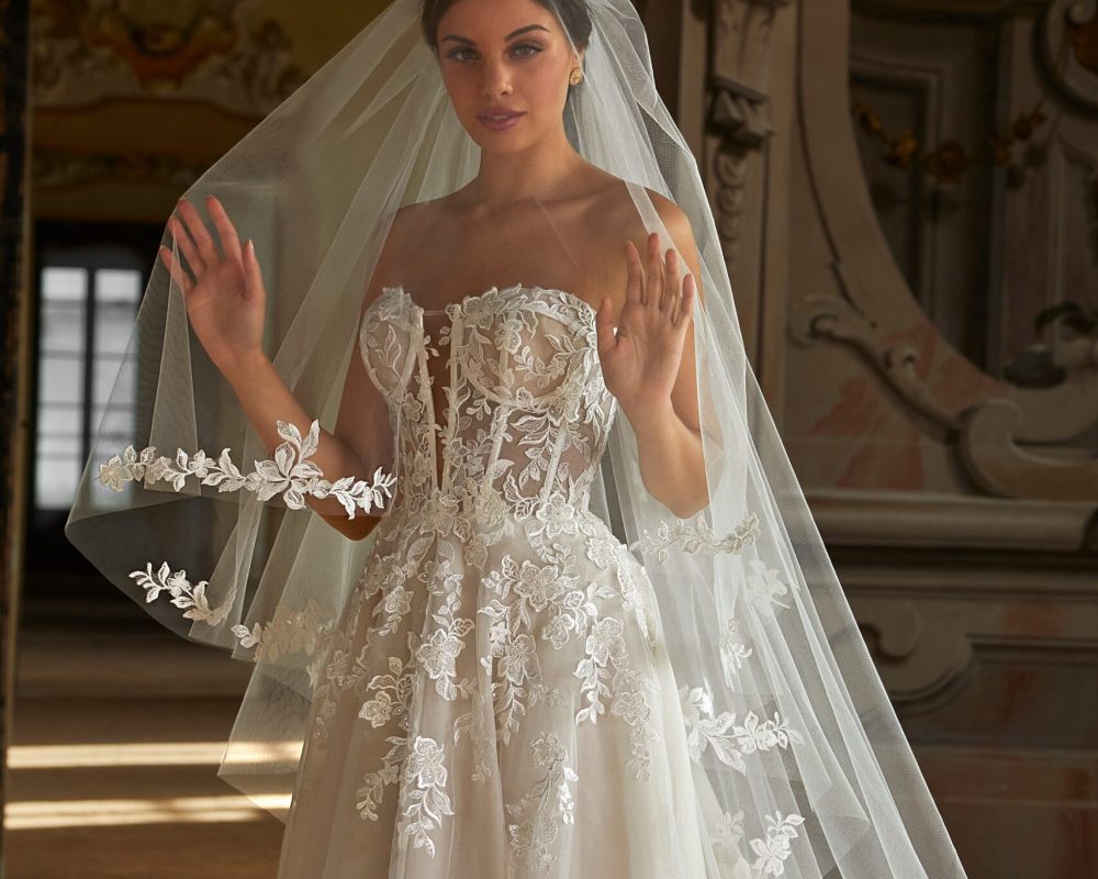 Bride in a strapless gown with veil indoors by The Sposa Group Melbourne Wedding Dress Designer.