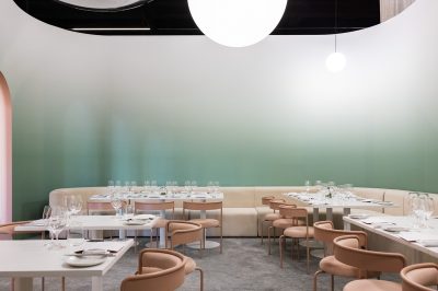 Indoor wedding reception in arc neutral and pink colored banquette