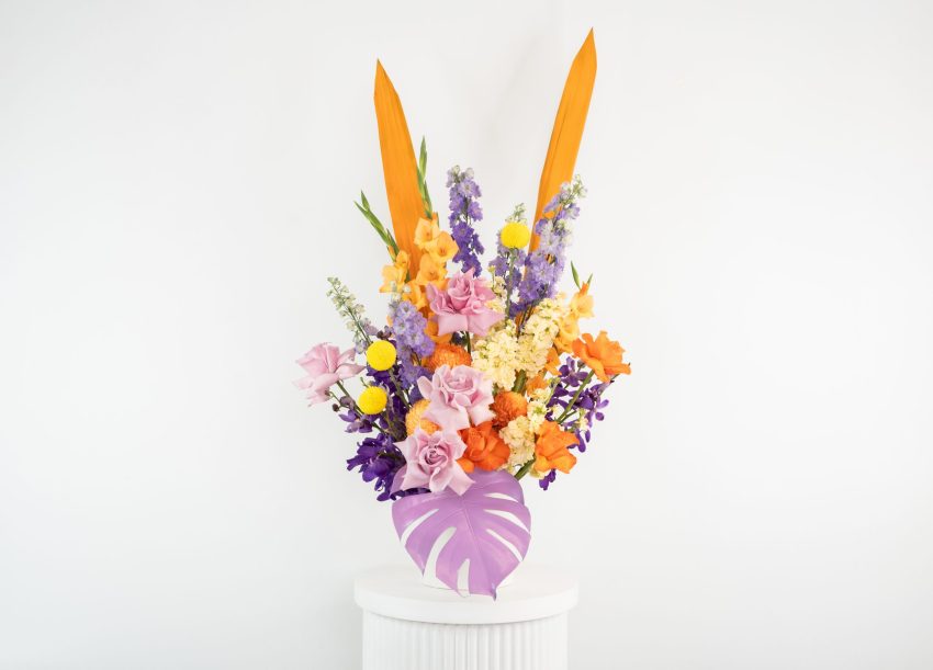 A vibrant bouquet of flowers displayed in a vase, showcasing a beautiful array of colors and floral varieties.