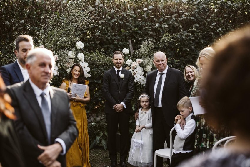 A couple exchanging vows surrounded by family and friends.