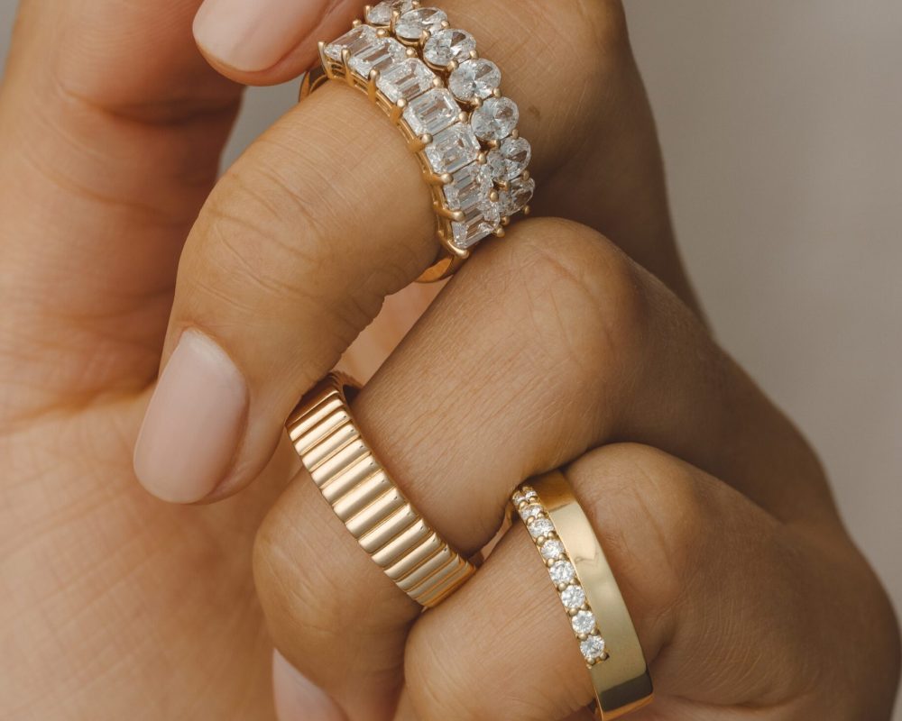 Three varieties of diamond engagement rings on the finger by Kavalri Jewellery Diamond Engagement Rings Australia.