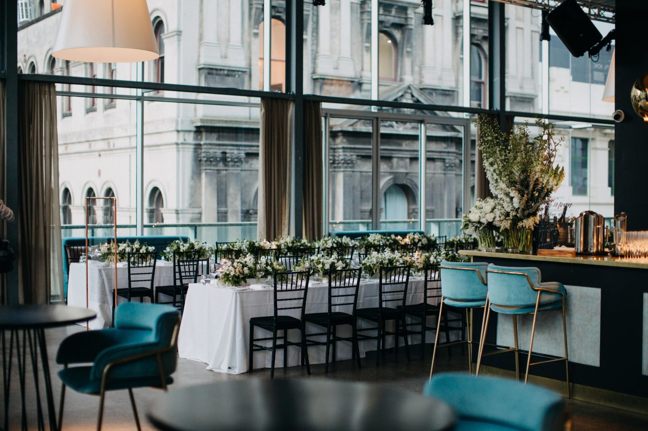 A wedding venue with clean minimalistic space with turquoise colored fixtures.