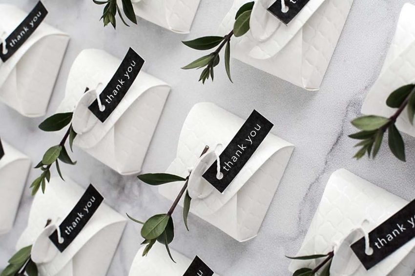 White paper bags with black labels on a table.