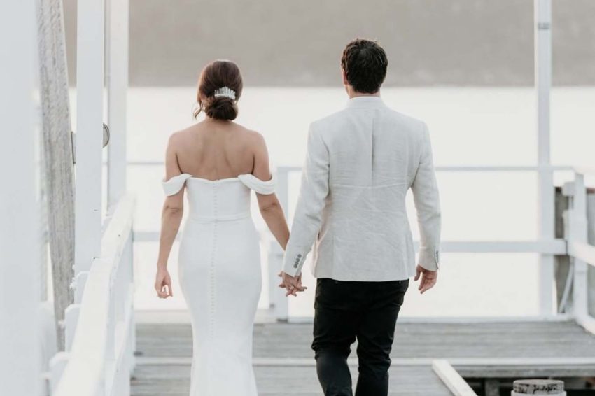 back view of wedding couple having a simple and secured wedding during the coronavirus