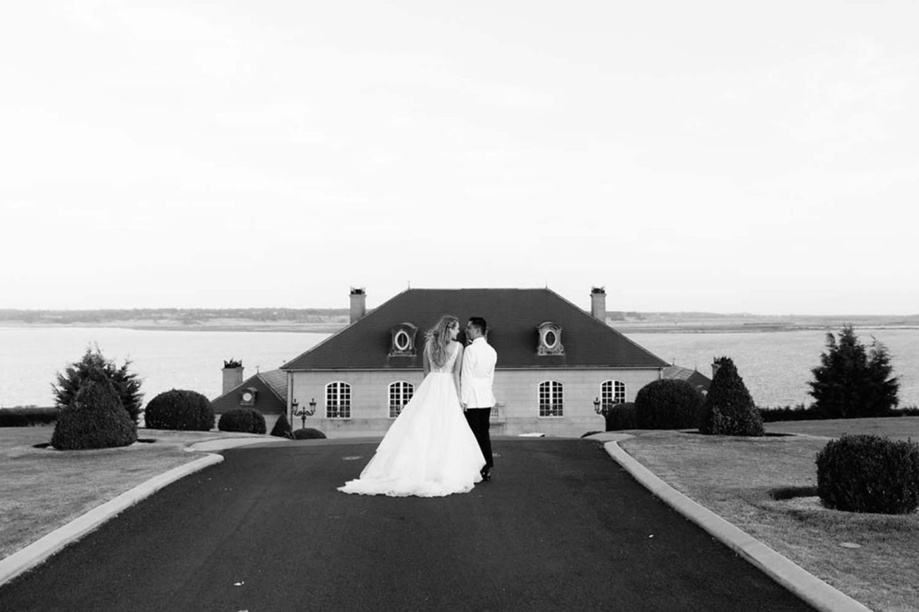 a married couple looking at each other at a beautiful wedding venue