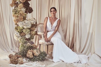 beautiful bridal separates model sitting in an elegant chair