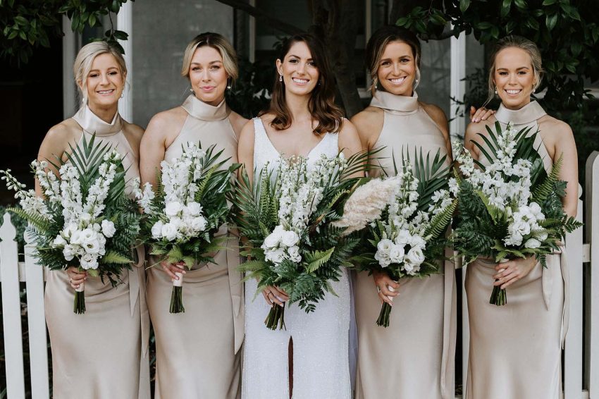 the bride and bridesmaids holding bouquet of flowers with the best wedding style