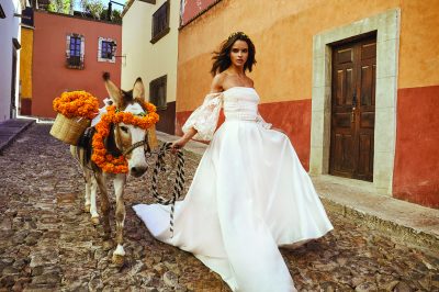 wedding dress model walking down the street with a mule