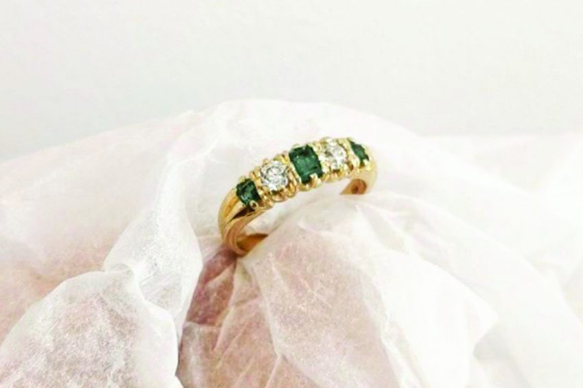 A gold wedding ring with gemstones