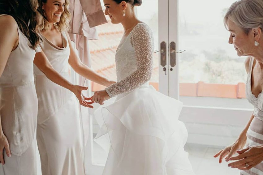 women discussing about wedding dates trying out wedding dresses