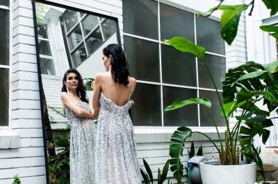 Bridesmaid model trying out a bridesmaid dress infront of a mirror