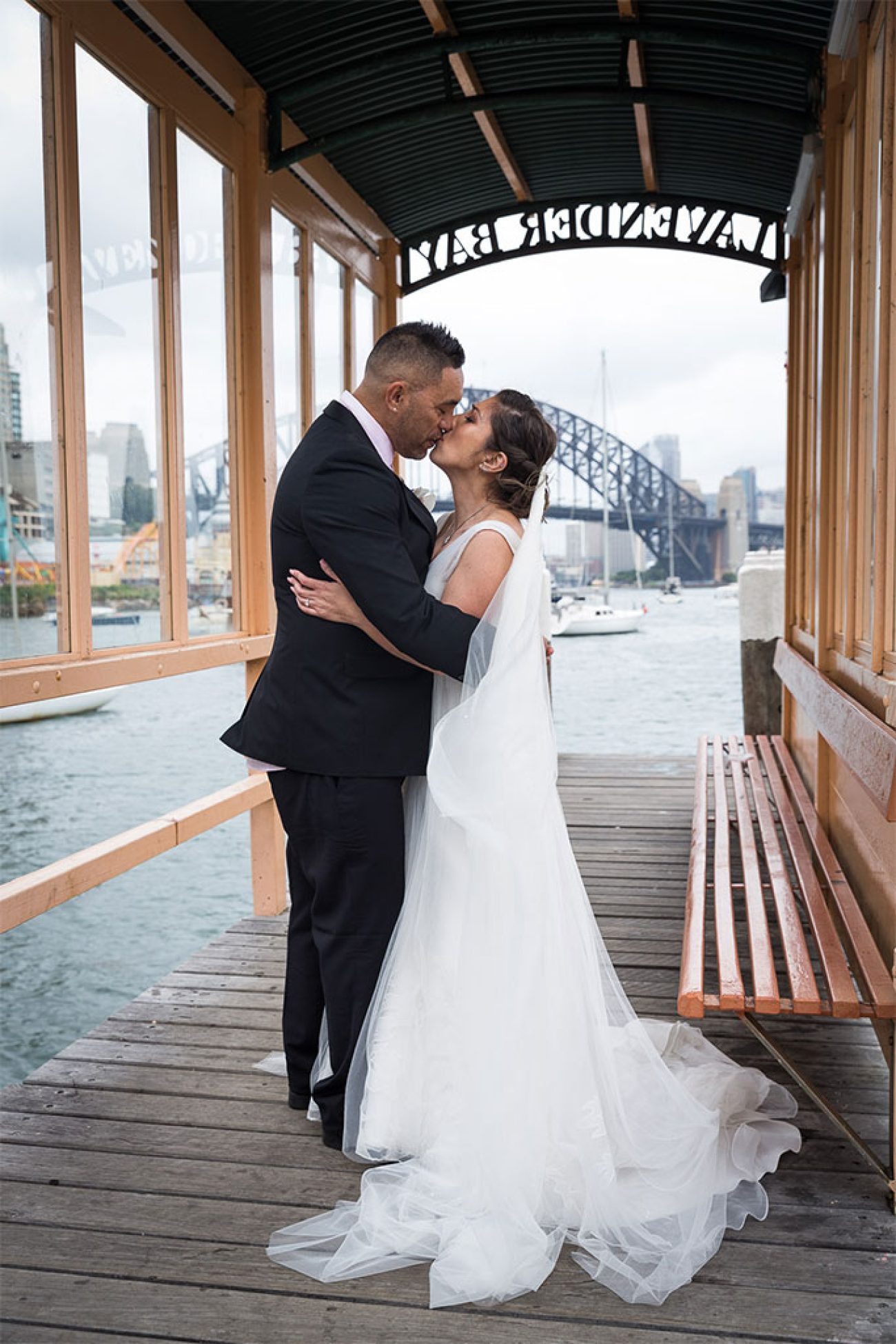 a photo of the bride and groom kissing on their wedding