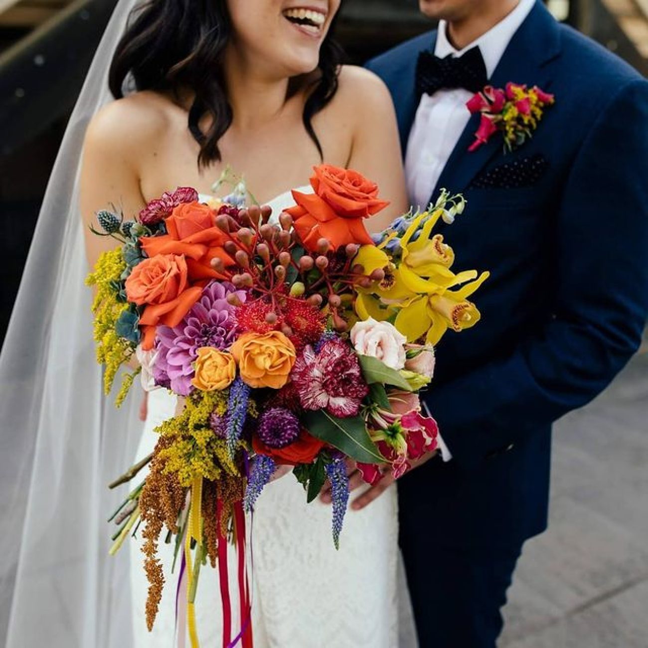 beautiful wedding bouquet held by the couple